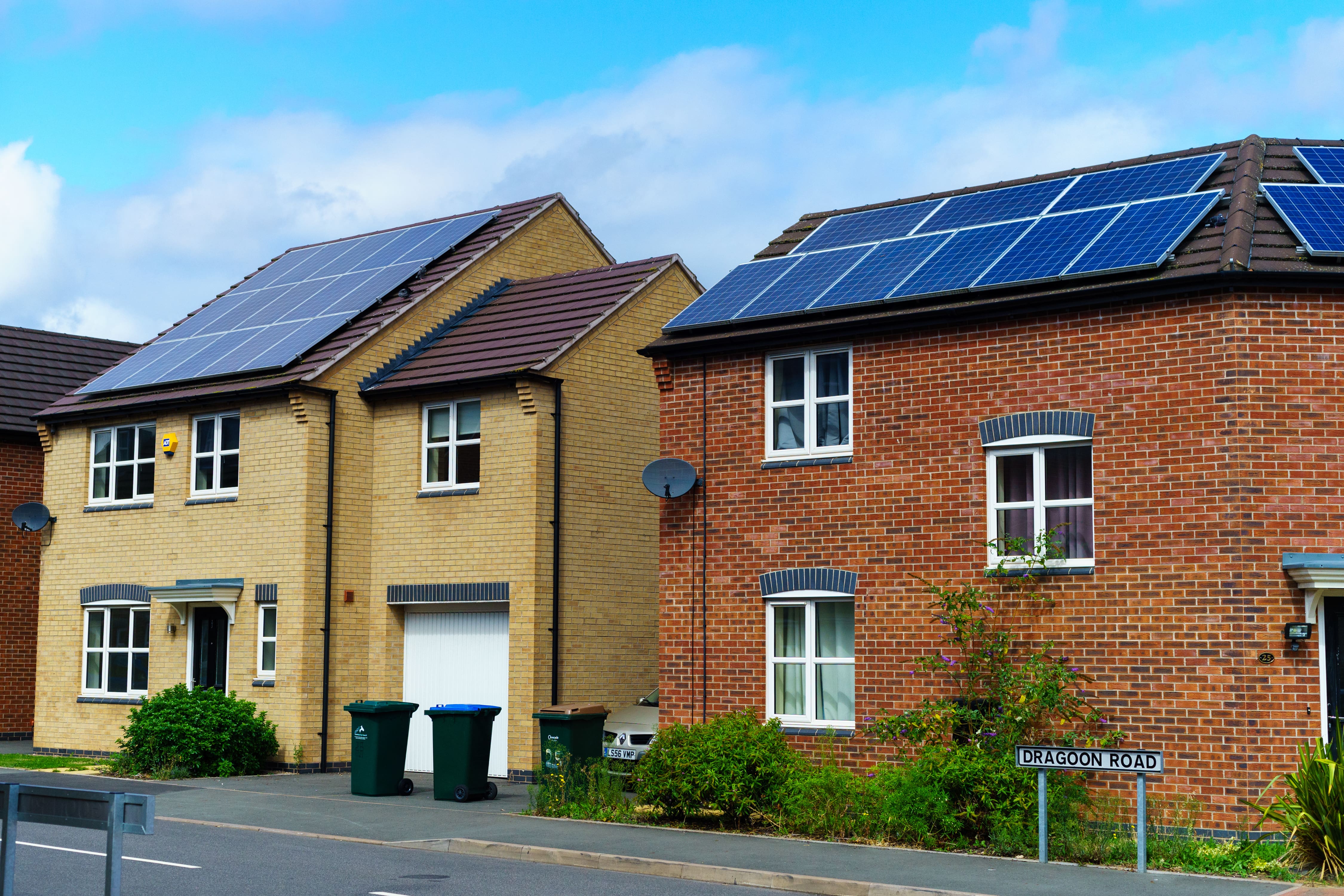 2 houses with solar panels on